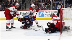 Carl Soderberg z Colorada padá mezi dvojicí Jordan Staal (vlevo) a Trevor van... Carl Soderberg z Colorada padá mezi dvojicí Jordan Staal (vlevo) a Trevor van...