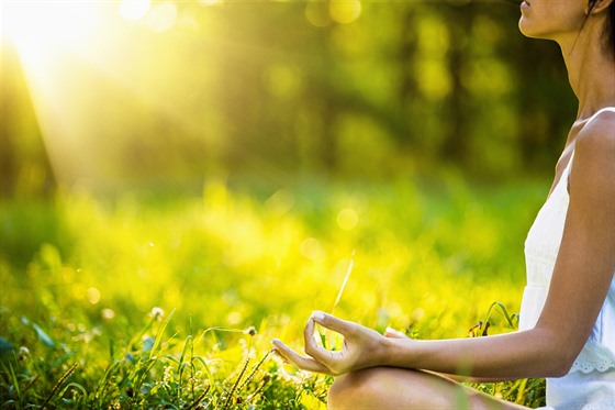Yoga woman meditating at sunset