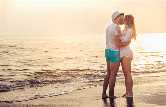 Couple in love having romantic tender moments at sunset on the beach