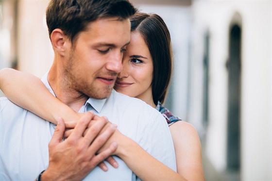 Young couple in love huggin on street