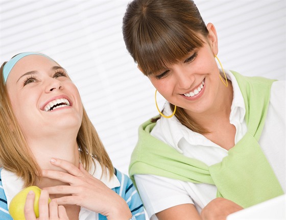 Student at home - two happy young woman with laptop