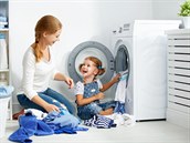 66956956 - family mother and child girl little helper in laundry room near washing machine and dirty clothes