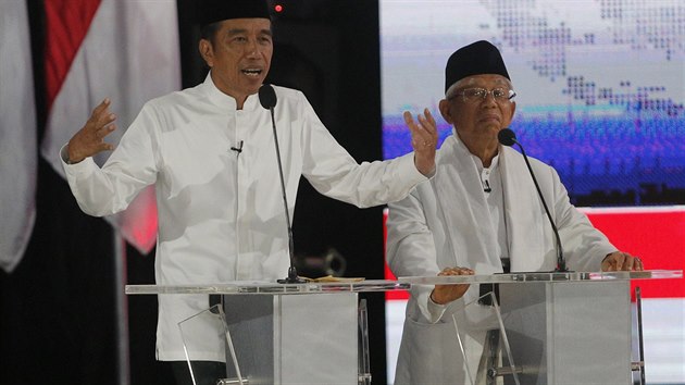 In this Saturday, April 13, 2019, file photo, Indonesian President Joko Widodo, left, delivers a speech with running mate Ma'ruf Amin, right, during a televised presidential candidate debate in Jakarta, Indonesia. The Indonesian presidential election is the world’s biggest direct vote for a national leader. (AP Photo /Tatan Syuflana, File)