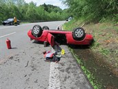 Červený kabriolet skončil koly vzhůru. Červený kabriolet skončil koly vzhůru.