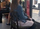 Žena využila svou přepravovanou židli k jejímu původnímu účelu, byť na neobvyklém místě. Žena využila svou přepravovanou židli k jejímu původnímu účelu, byť na neobvyklém místě.