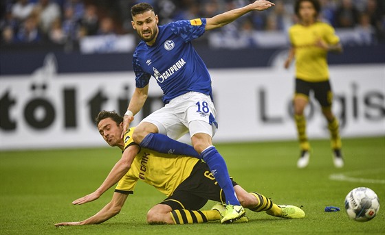 Daniel Caligiuri ze Schalke (v modrém) a Thomas Delaney z Dortmundu bhem...