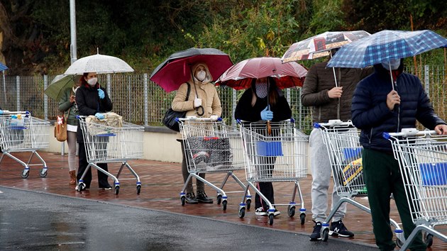 Lid na italsk Siclii ekaj ve front na vstup do supermarketu. (23. bezna 2020)