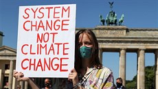 Zmna systému, ne klimatu, hlásá transparent mladé demonstrantky v Berlín....