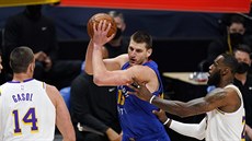 Nikola Jokič z Denveru se snaží uvolnit, brání ho Marc Gasol a LeBron James z... Nikola Jokič z Denveru se snaží uvolnit, brání ho Marc Gasol a LeBron James z...