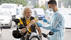 Zdravotnický pracovník okuje v drive-in centru v Berlín. (17. ervence 2021)