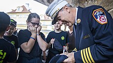 U pilíře Karlova mostu na pražské Kampě si v sobotu newyorský hasič James... U pilíře Karlova mostu na pražské Kampě si v sobotu newyorský hasič James...