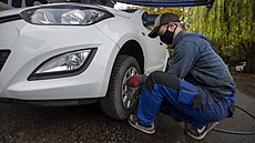 Pracovník jednoho z pražských autoservisů vyměňuje 23. října 2020 letní... Pracovník jednoho z pražských autoservisů vyměňuje 23. října 2020 letní...