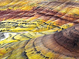 Layers of breathtaking colour streak the rolling hills of this vast desert,...