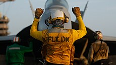 Námoník nejvtí letadlové lodi svta USS Gerald R. Ford dává znamení letadlu...