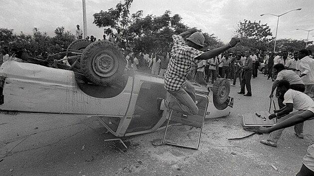 Propletenost gang ve smyslu paramilitrnch skupin a politiky sah na Haiti destky let zptky. Sv mimosttn vykonavatele vrad, zastraovn a nsilnost Tonton Macoutes ml dikttor Francois Duvalier. Na snmku z roku 1986 si s Tonton Macoutes vyizuj Haian ty, protesty proti nezamstnanosti, bd a tlaku tehdy vyhnaly ze zem Duvalierova nstupnka, jeho syna Jean Clauda.