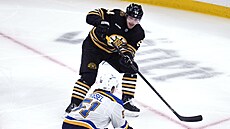 Jakub Lauko (94) z Boston Bruins pihrává v zápase se St. Louis Blues kolem...