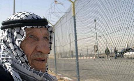 Palestinec stojí u hranice Egypta a Gazy ped jejím otevením.