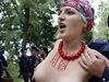 Policista odvádí jednu z aktivistek ze sdruení FEMEN