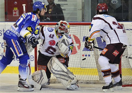 estý zápas tvrtfinále play off hokejové extraligy Kometa Brno - Sparta Praha. Jakub Svoboda z Brna (vlevo) dává druhý gól Komety do brány sparanského gólmana Tomáe Pöpperleho. Vpravo sparanský Troy Milam. 