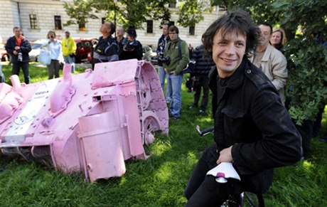 David erný smiles as authorities prepare to remove his fragment Pink tank  illegally installed to commemorative the 40th anniversary of the invasion Warsaw Pact troops
