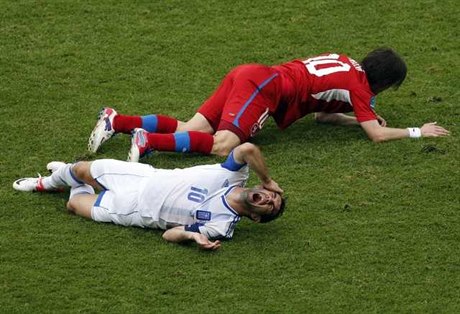 Greece's Giorgos Karagounis cries in pain after being kicked on the face by Czech Republics Tomá Rosický during Tuesdays match