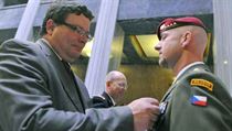 Defense Minister Alexandr Vondra (TOP 09) decorates a soldier Defense Minister Alexandr Vondra (TOP 09) decorates a soldier
