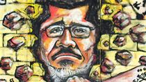 Graffiti zesměšňující ve středu odvolaného egyptského prezidenta Muhammada Mursího na zdi prezidentského paláce v Káhiře. Graffiti zesměšňující ve středu odvolaného egyptského prezidenta Muhammada Mursího na zdi prezidentského paláce v Káhiře.