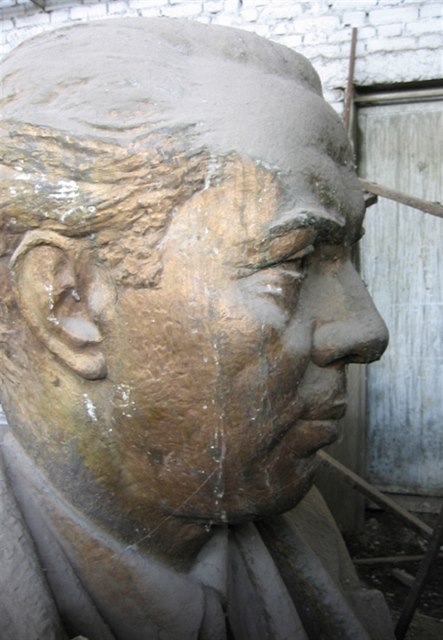 A discarded bust of Albanian dictator Enver Hoxha reflects on the "stimulant of oppression"