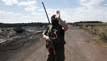 Ozbrojený separatista gestikuluje na novináře na místě zřícení letu MH17. | na serveru Lidovky.cz | aktuální zprávy