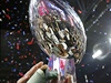 Members of the New England Patriots hold up the Vince Lombardi Trophy after...