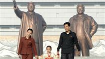 Severokorejsk rodina. Na pozad usmvav sochy Kim Ir-sena a Kim ong-ila