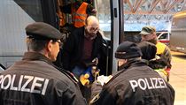 Rakousk policista kontroluje idenitifkan doklady migrant, ne jim povol...