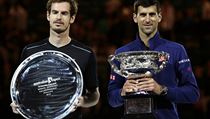 Novak Djokovic, right, of Serbia holds his trophy after defeating Andy Murray,...