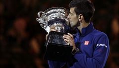 Novak Djokovic of Serbia kisses his trophy aloft after defeating Andy Murray of...