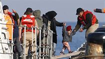 Uprchlci vystupuj z lodi poben hldky zptky na tureck zem.