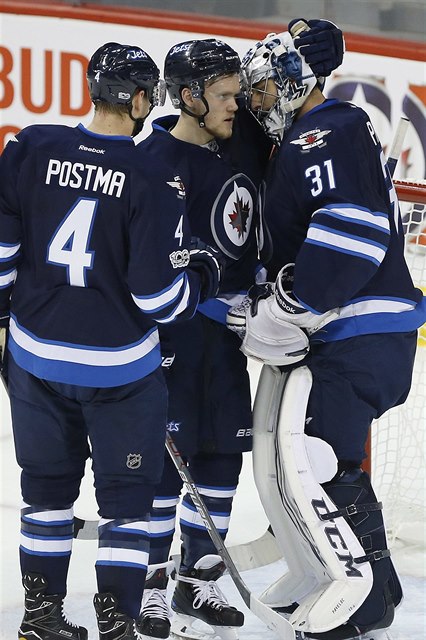 eský gólman Ondej Pavelec pijímá gratulace od spoluhrá po výhe Winnipegu...