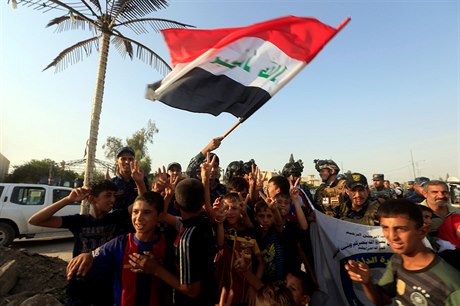 Irácká federální policie slaví s dtmi v západním Mosulu.