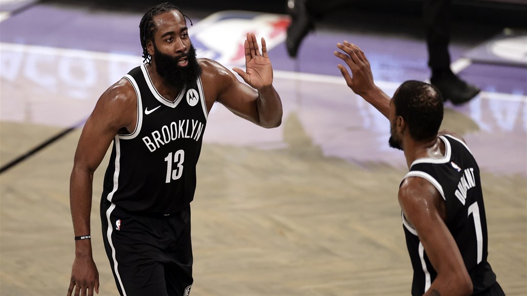 Brooklyn Nets guard James Harden celebrates with forward Kevin Durant (7)...