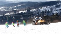Ve skiareálu Rejdice tahá malé lyžaře sněžný skútr.