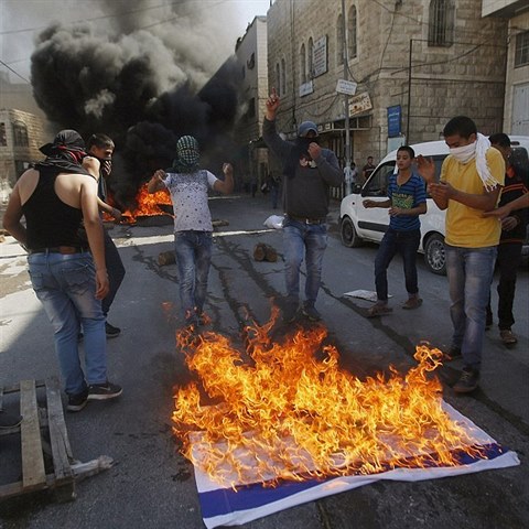 Palestinci pl izraelskou vlajku.