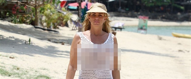 *PREMIUM-EXCLUSIVE* Katie Price seen walking along the beach topless in a see through dress in Thailand *WEB EMBARGO UNTIL 5:25 pm ON 18/03/19* *MUST CALL FOR PRICING*