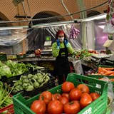 A market worker wears a mask, in Pamplona, northern Spain, Monday, March 16,...