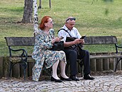 Iva Janurová s neznámý muem na lavice v parku