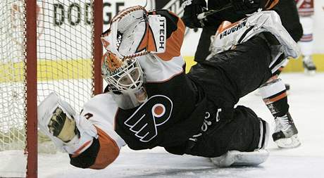 Gólman Martin Biron z Philadelphie skáe do stely v utkání proti Rangers.