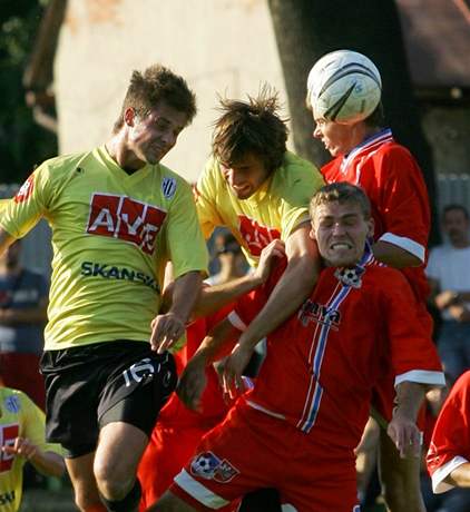 Fotbalisté Velkého Meziíí (v erveném) v hlavikovém souboji s hrái Budjovic ve 2.kole Poháru MFS