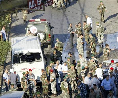 Písluníci armády a policie ohledávají místo, kde vybuchl autobus s vojáky