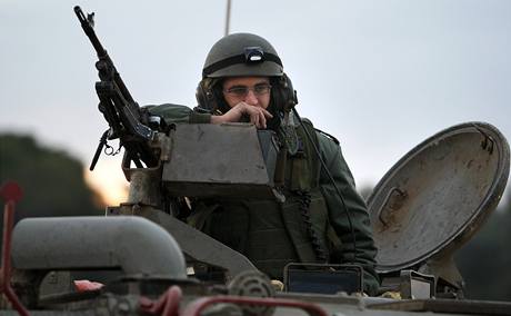 Izraelský voják eká v obrnném vozidle na vjezd do pásma Gazy.