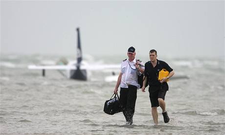 Pilot letadla Steve Bolle (vlevo) se spolu s jedním z pti pasaér brodí ke behu.