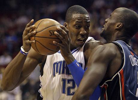 Orlando - Charlotte: Dwight Howard z Orlanda (vlevo) útoí pes Emeka Okafora z Charlotte.