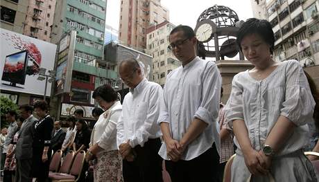 na si dnes pipomn niiv zemtesen v provincii S'-chuan. Na snmku lid v Hongkongu uctvaj obti minutou ticha.(12. kvtna)